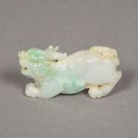 A Chinese carved pale green jade temple lion 8 cm long.