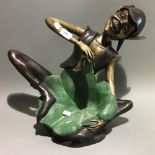 A bronze model of a pixie