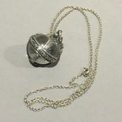 A rock crystal silver mounted pendant orb on chain