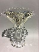 A sterling silver and glass vase with beaded handles,