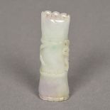 A Chinese carved celadon jade group Worked as a section of bamboo. 7.5 cm long.