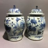 A pair of Chinese blue and white jars and covers