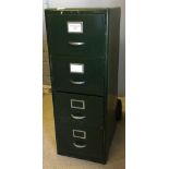 A vintage green painted metal filing cabinet