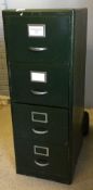 A vintage green painted metal filing cabinet