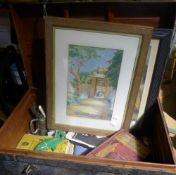 A trunk containing miscellaneous items, including paintings and prints,