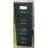 A vintage green painted metal filing cabinet