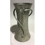 An English pewter Arts and Crafts vase of waisted form and applied flower stems