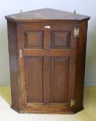 A George III oak corner cupboard