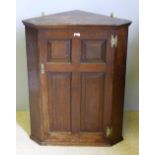 A George III oak corner cupboard