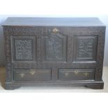 An 18th century oak mule chest The hinged rectangular top above the carved three panel front with