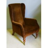 A Victorian upholstered wing armchair