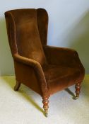 A Victorian upholstered wing armchair