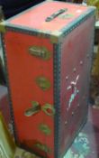 A vintage red travelling trunk