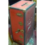 A vintage red travelling trunk