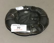 A Continental pewter life ring and fish form ashtray