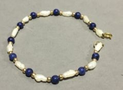 A freshwater pearl and lapiz bracelet