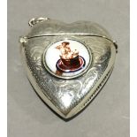 A silver vesta in the form of a heart