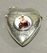 A silver vesta in the form of a heart