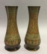 A pair of bronze Middle-Eastern vases with decoration