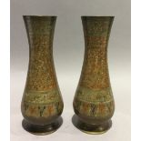 A pair of bronze Middle-Eastern vases with decoration