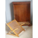 A modern bookcase and a caned stool