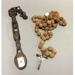 A carved Continental crucifix with rosary beads,