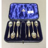A cased set of silver teaspoons and tongs