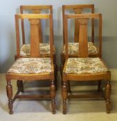 A set of four early 20th century oak dining chairs