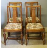 A set of four early 20th century oak dining chairs
