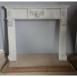 A painted fire surround and a brass fender