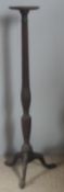 An Edwardian mahogany torchere