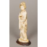 A 19th century Japanese carved ivory okimono Of a standing Geisha. 18 cm high.