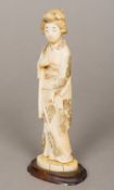 A 19th century Japanese carved ivory okimono Of a standing Geisha. 18 cm high.
