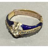 A gold diamond and enamel ring