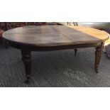 A large Victorian oak extending dining table