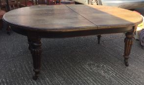 A large Victorian oak extending dining table