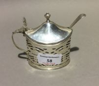 A mustard pot with liner and spoon