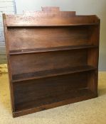 A pine bookcase and a small set of oak hanging shelf