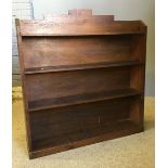 A pine bookcase and a small set of oak hanging shelf