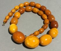 A vintage string of butterscotch graduated amber beads