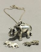 A silver elephant pendant on chain,