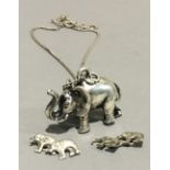 A silver elephant pendant on chain,