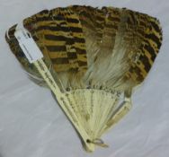 A decorated feather and bone fan