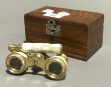 A pair of cased opera glasses