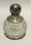 A silver mounted cut glass scent bottle