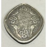 A silver pendant decorated with birds