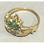 A 10 K gold diamond and emerald ring