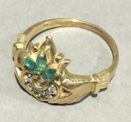 A 10 K gold diamond and emerald ring