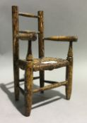 A scumble glazed miniature rush seated vernacular country chair