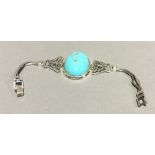 A silver and turquoise bracelet